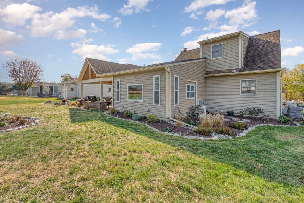 A home with a yard that looks like it is being revived thanks to good watering practices.